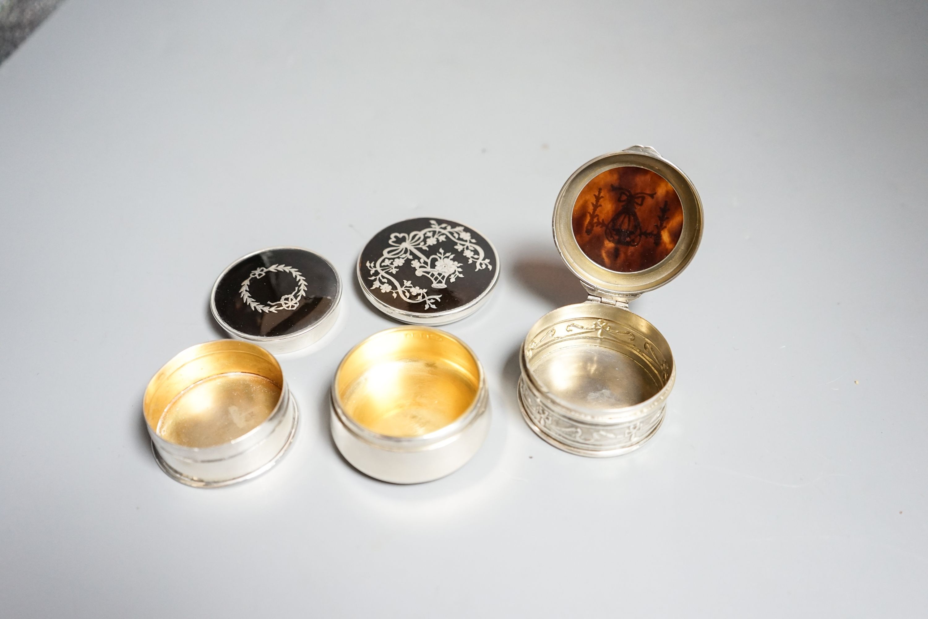 Three assorted early 20th century silver and tortoiseshell pique circular boxes and covers, two by Levi & Salaman, largest 58mm.